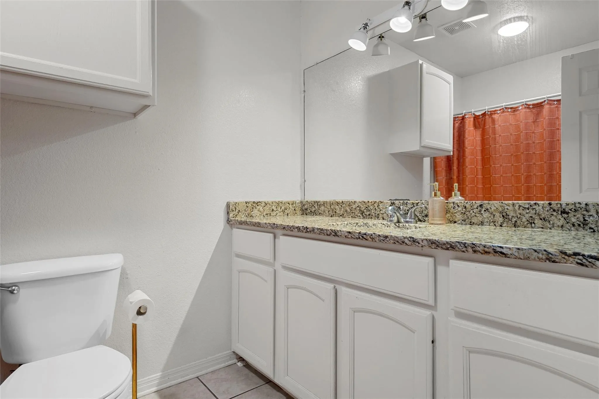 Bathroom featuring vanity and light tile patterned flooring