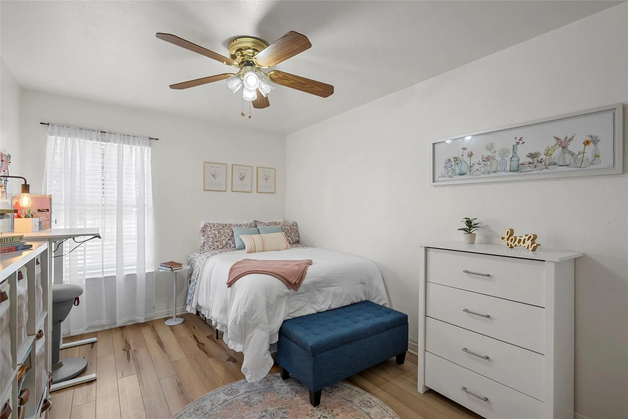 Bedroom featuring light wood-type flooring and a ceiling fan
