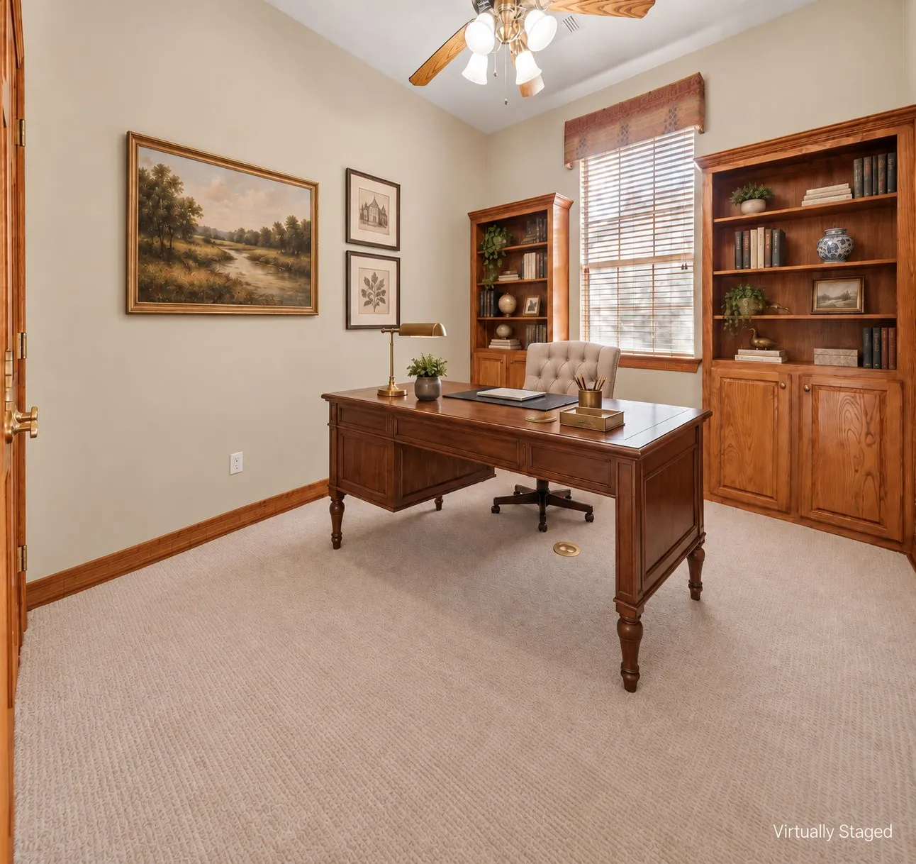 Built-in wood cabinetry, wood-finish door, light-toned carpeting, and a ceiling fan with integrated lighting