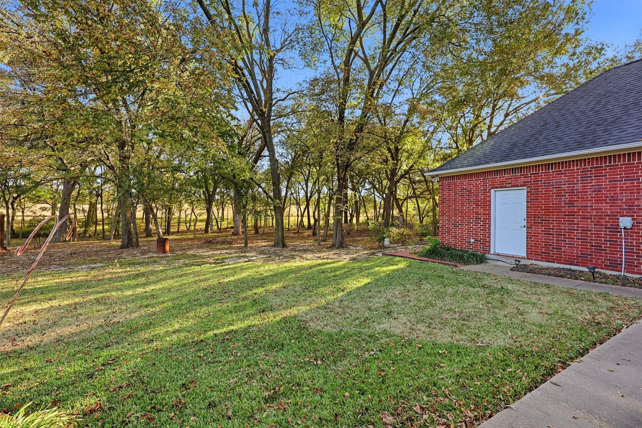 View of green side lawn in back of home