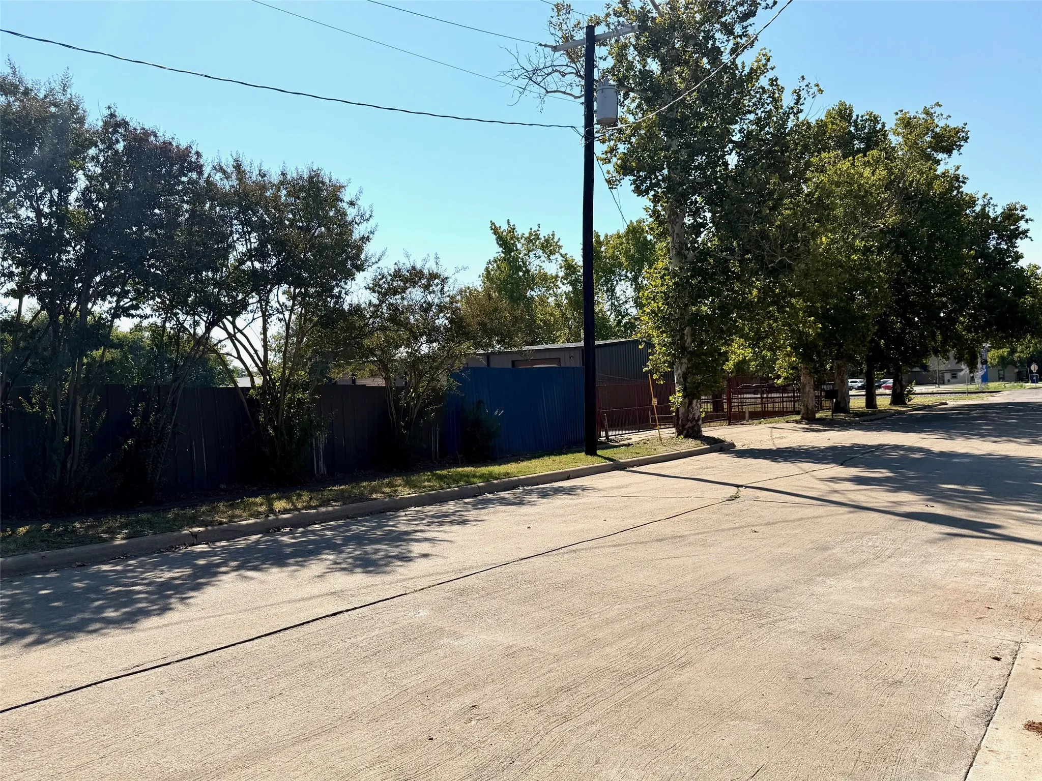 View of concrete road with curbs
