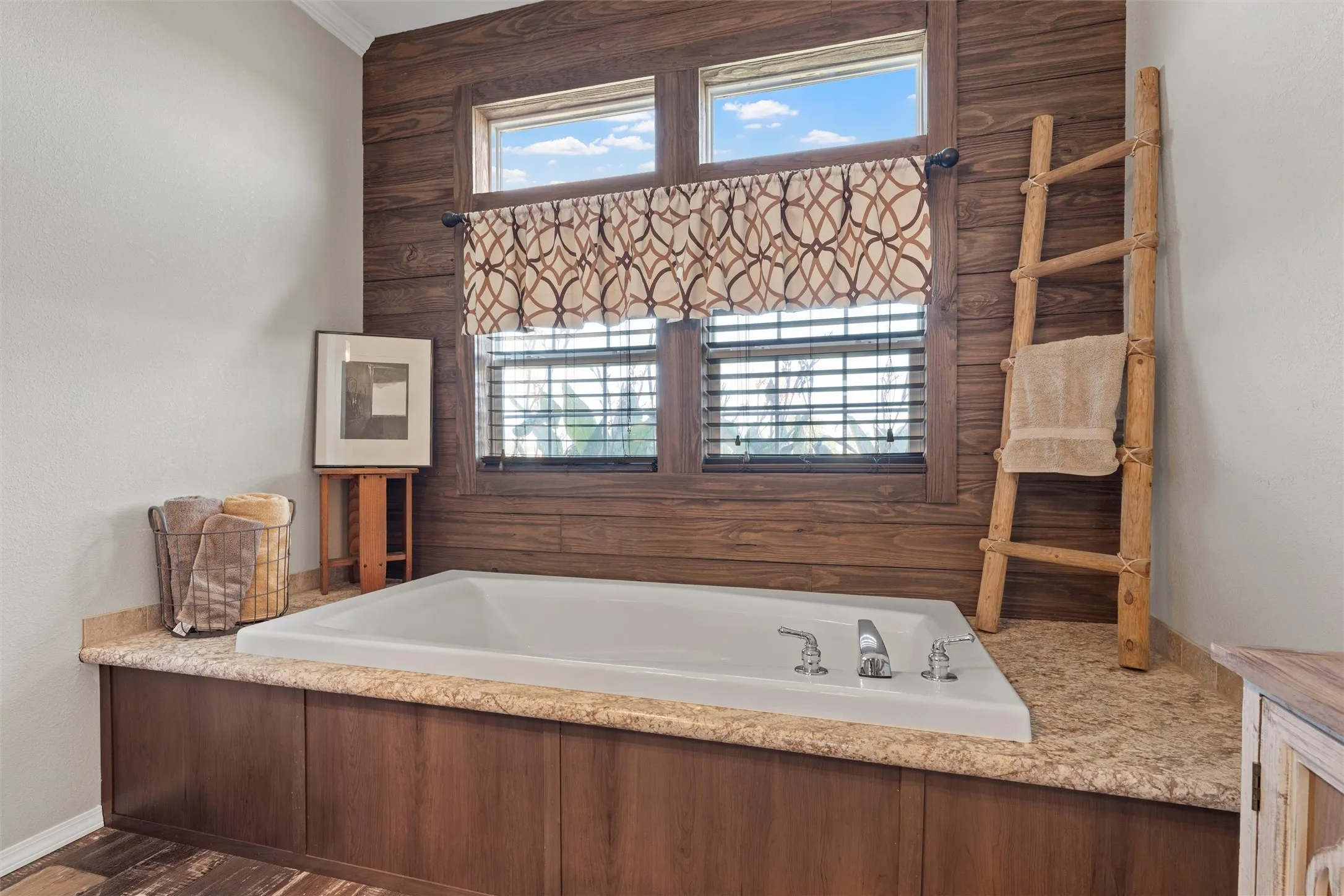 Full bath featuring a garden tub and dark wood-style floors