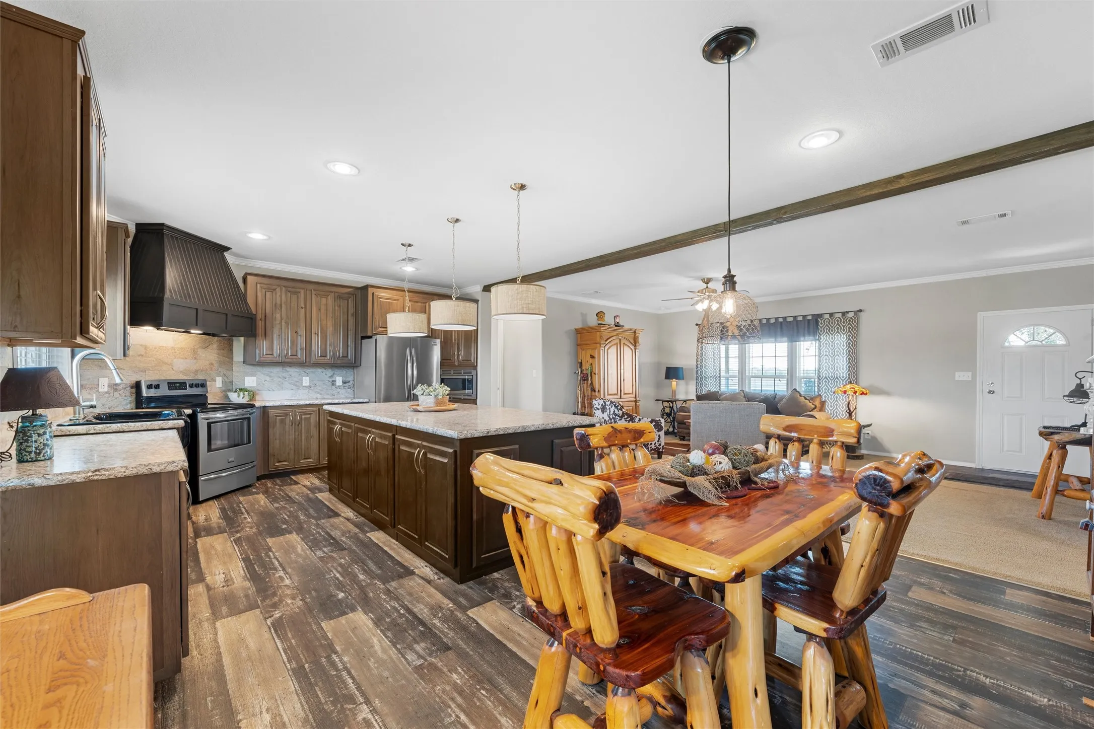 Dining area with dark wood-type flooring, crown molding, recessed lighting, a ceiling fan, and beam ceiling