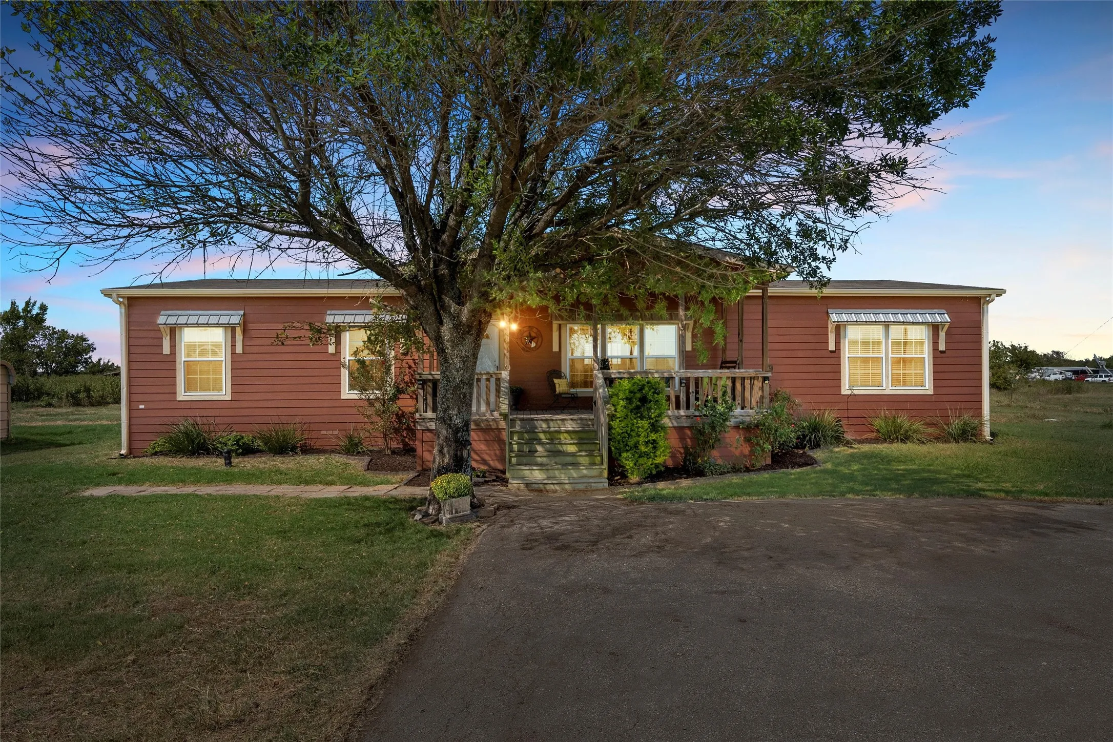 View of front facade with a front yard and a porch
