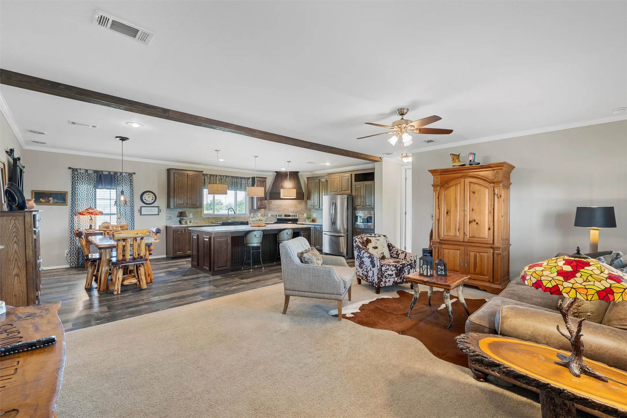 Living room with ornamental molding, dark wood-style floors, ceiling fan, beamed ceiling, and recessed lighting