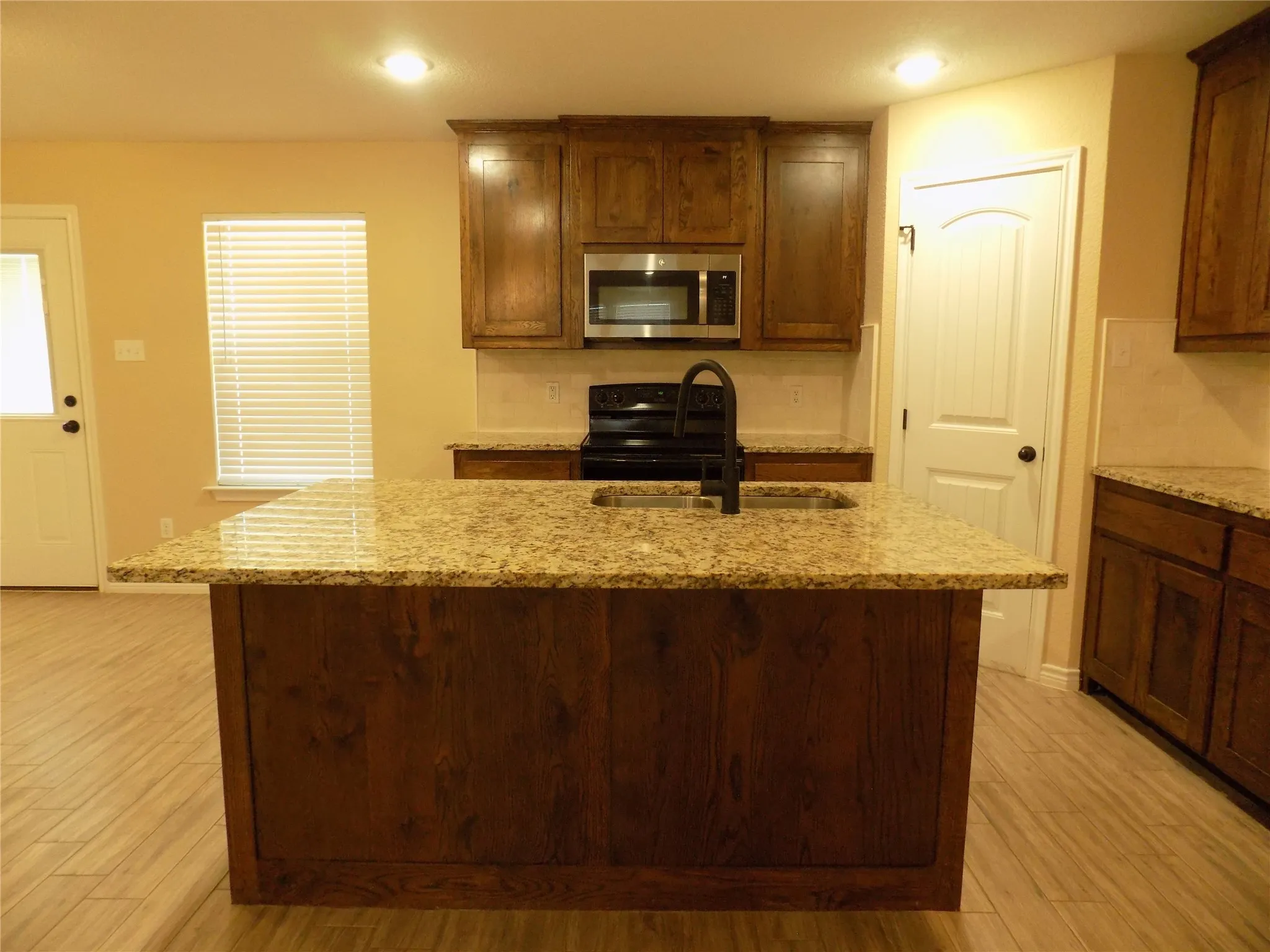 Wonderful kitchen island with large under cabinet double stainless sink