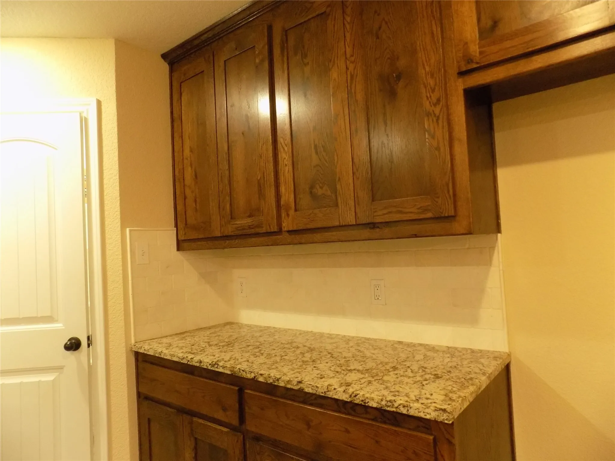 Extra cabinets and granite counter top space next to pantry