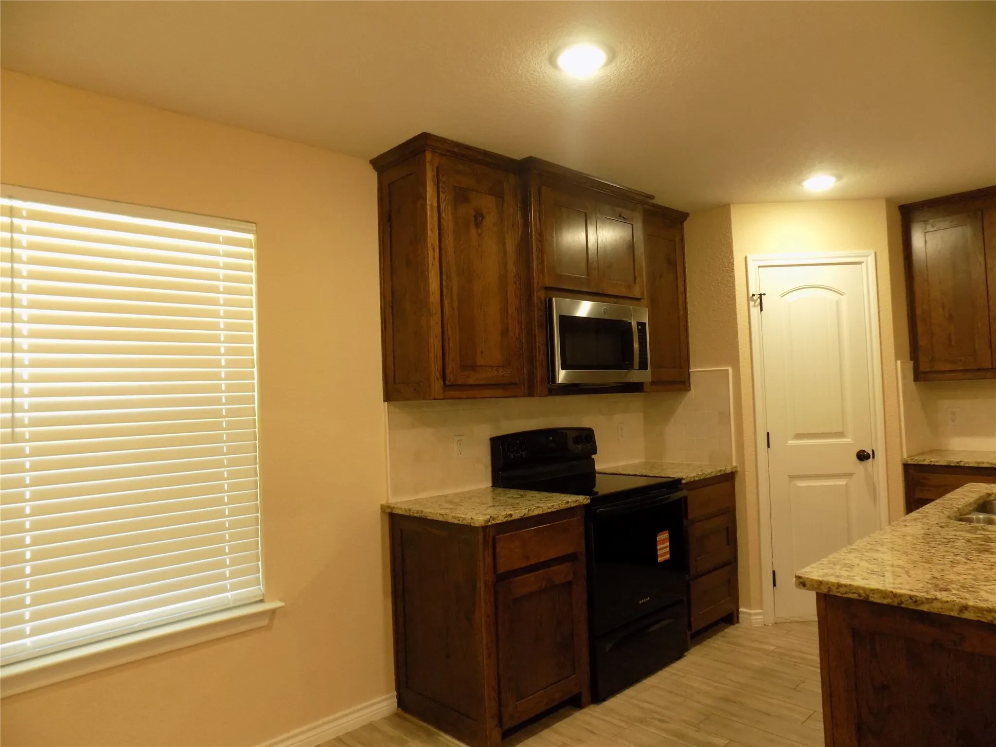 Stove and microwave , along with pantry door