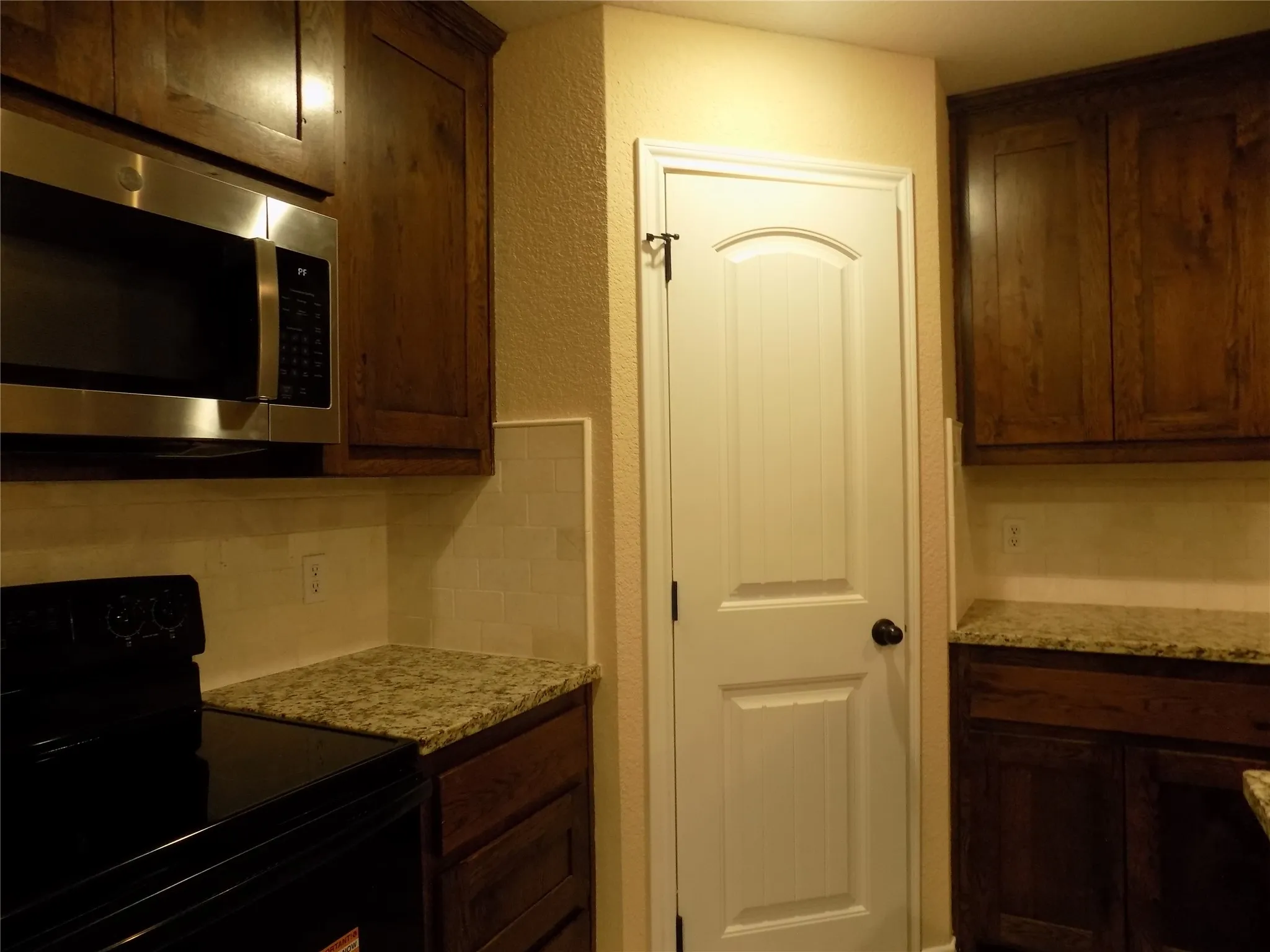 View of pantry location along with some of the kitchen appliances