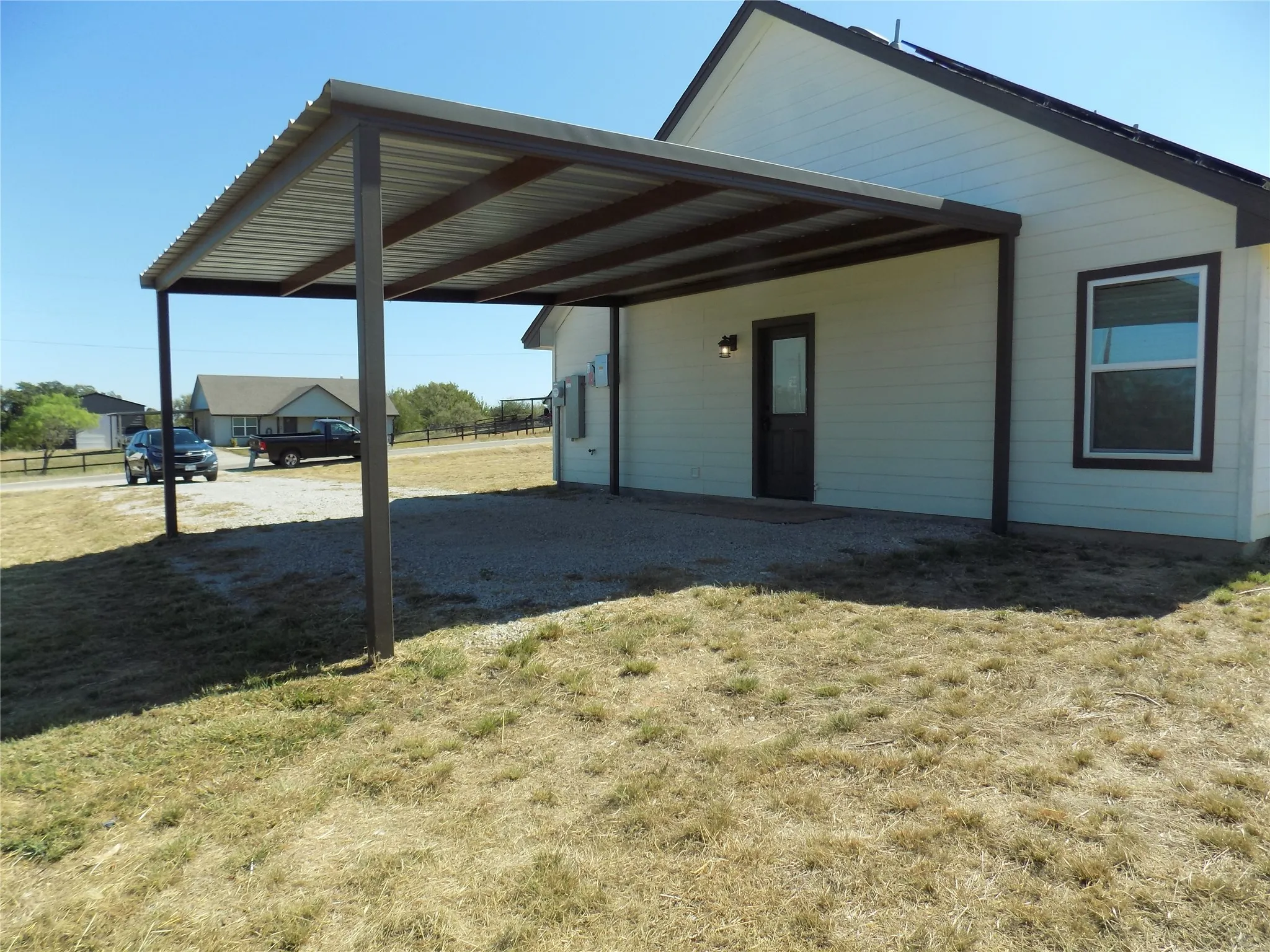 Attached carport with third entry door