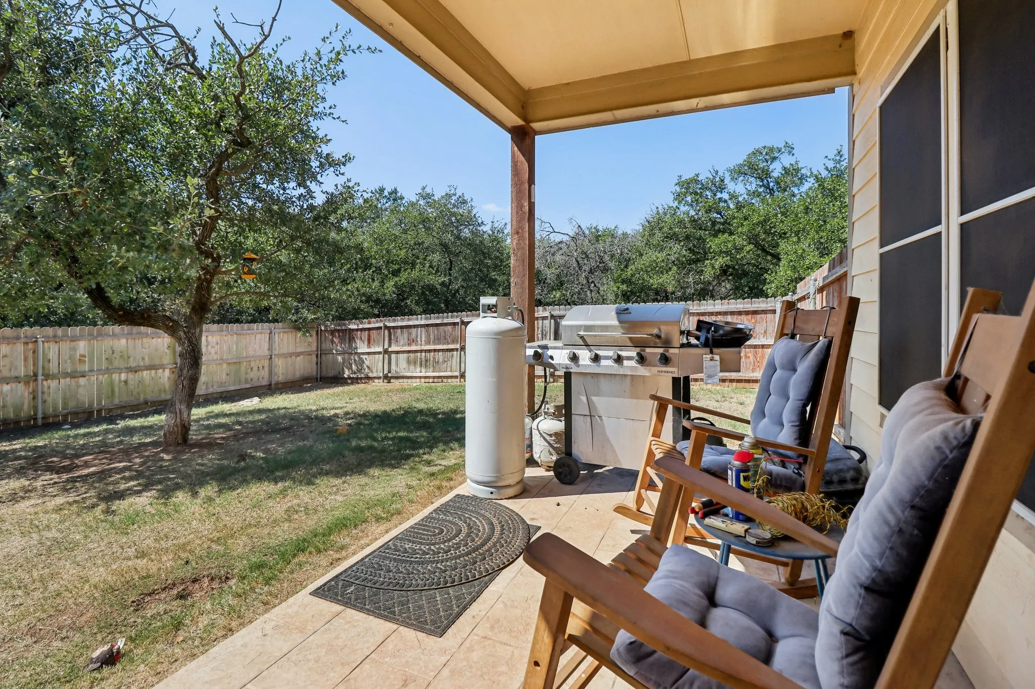 Covered back patio overlooking backyard