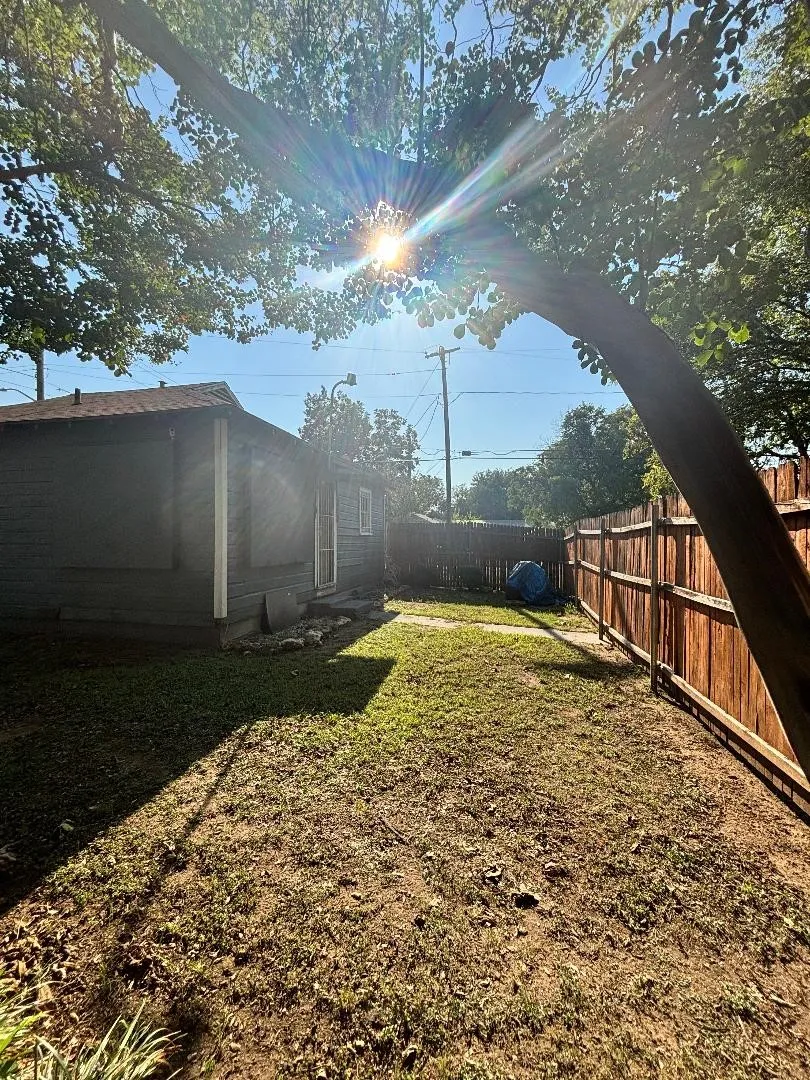 Behind the house.
