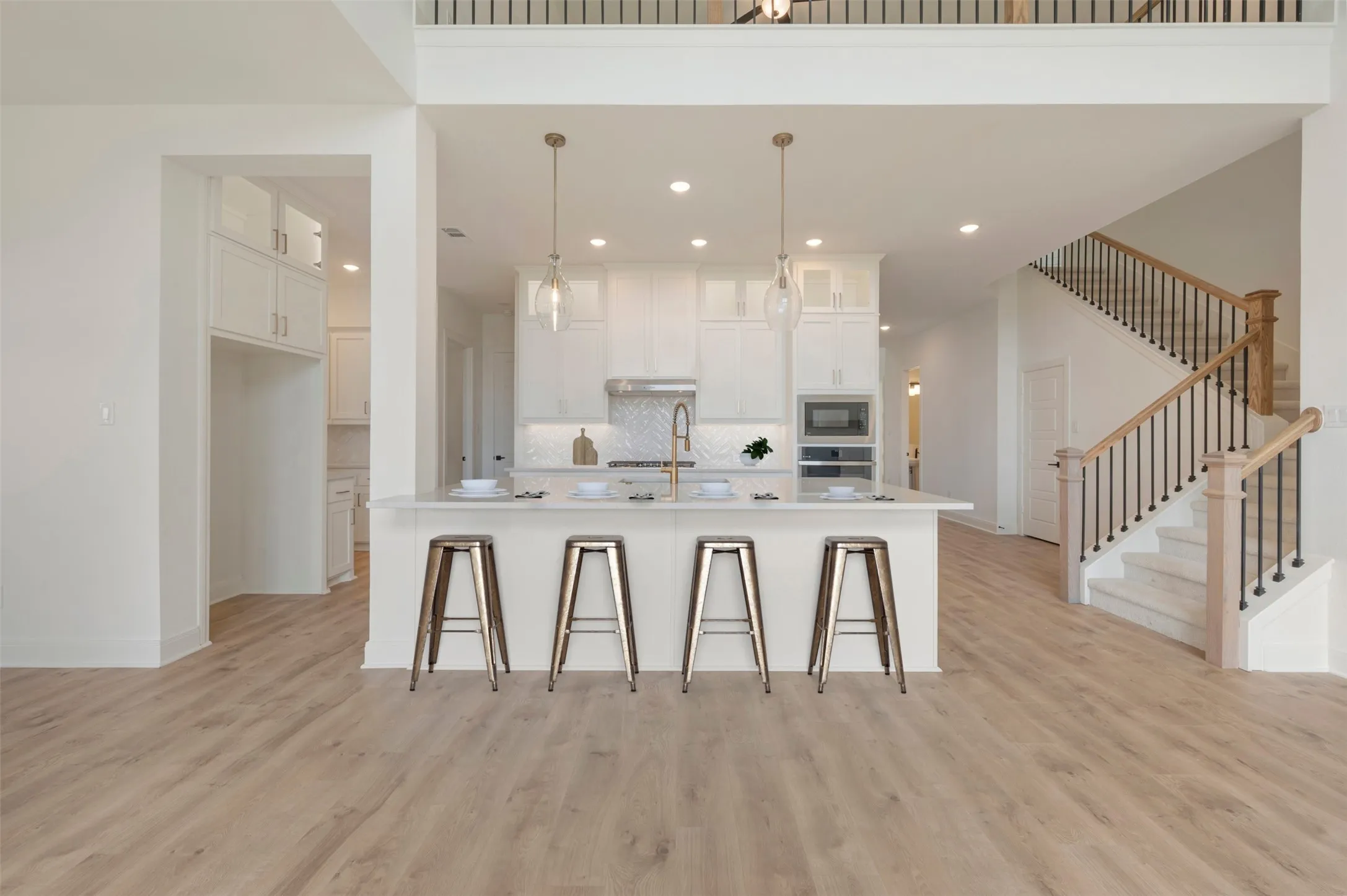 Open-concept living area featuring light wood-finish flooring
