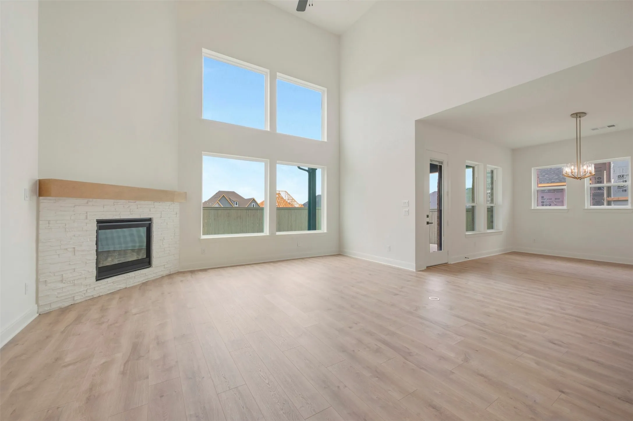 Spacious living area featuring a vaulted ceiling and wood-finish flooring
