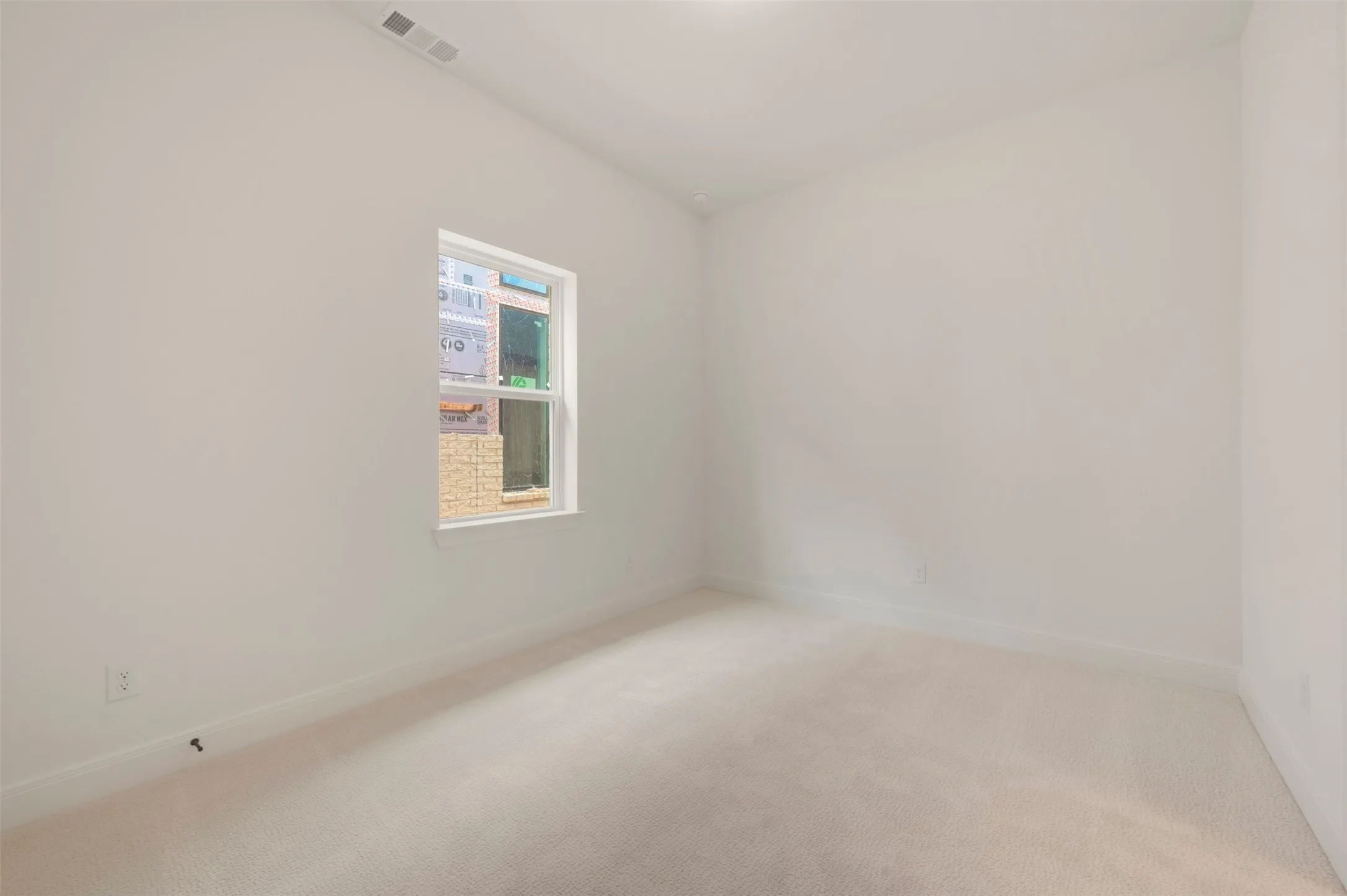 Neutral-toned carpeting and light-colored walls define this room