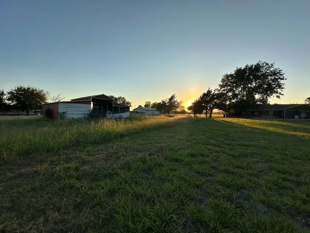 Yard at dusk featuring a yard