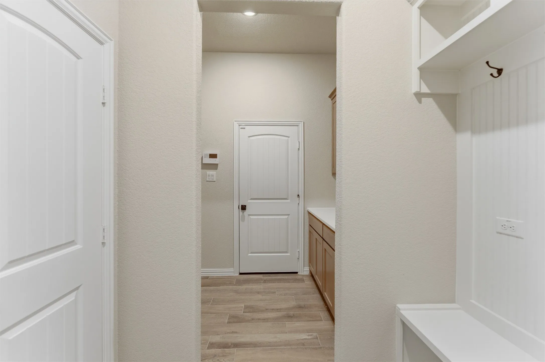 Mudroom featuring light wood-style flooring