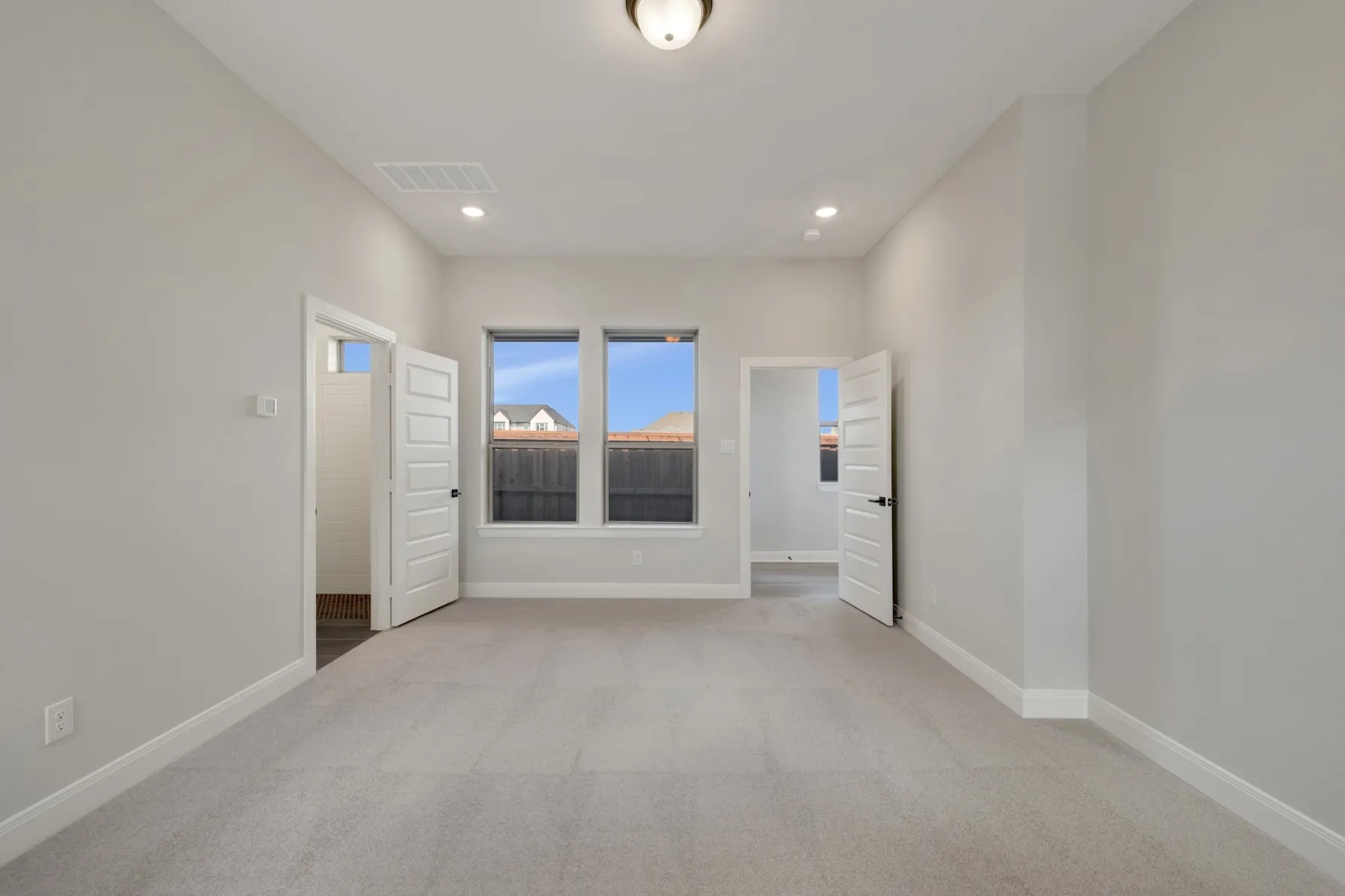Empty room featuring light colored carpet and recessed lighting