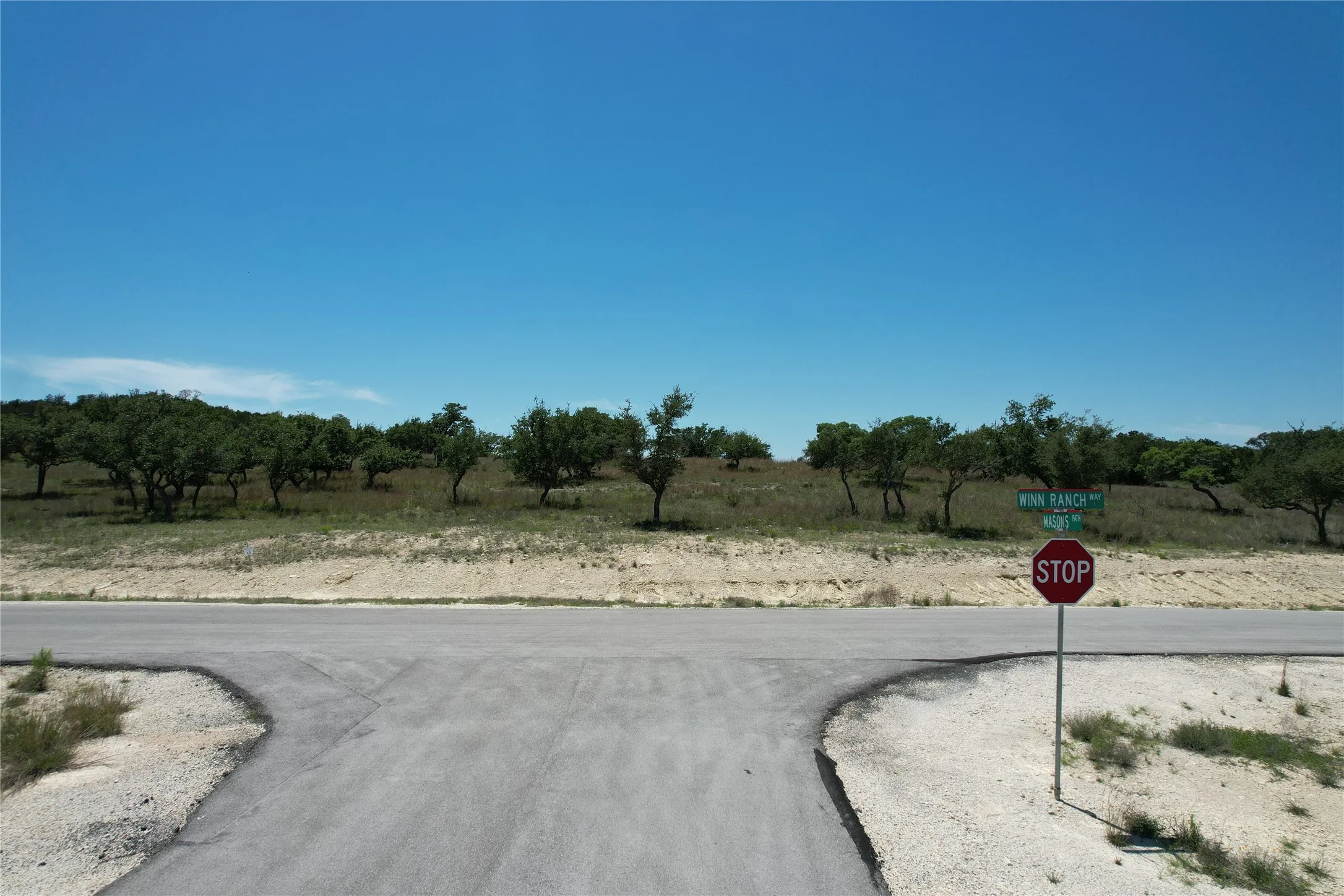 View of asphalt road with a view of rural / pastoral area and traffic​​‌​​​​‌​​‌‌​‌‌​​​‌‌​‌​‌​‌​​​‌​​ signs