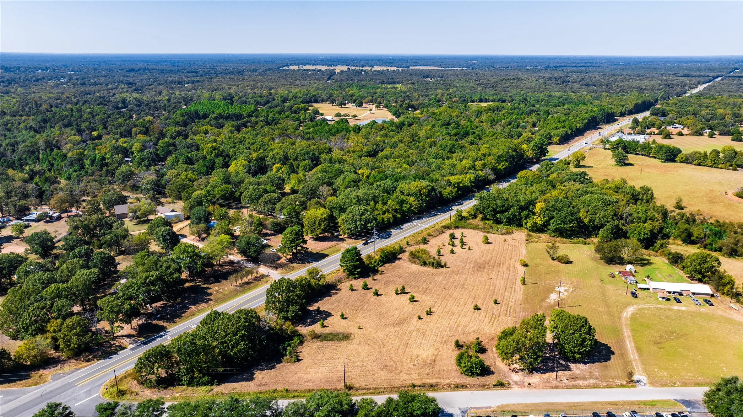 Aerial view of sparsely populated area featuring a heavily wooded area