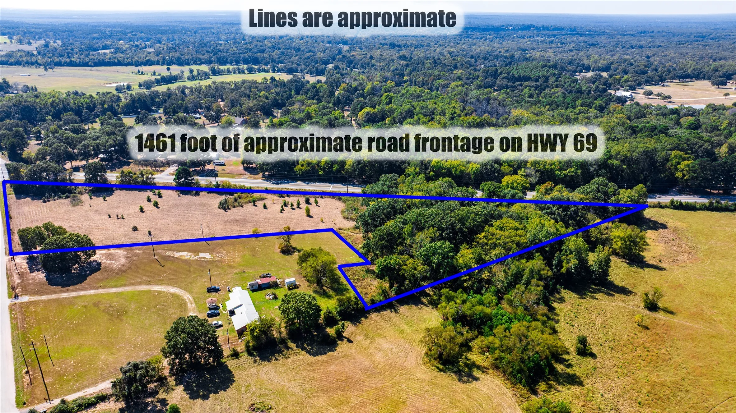 Aerial view of property and surrounding area with property parcel outlined