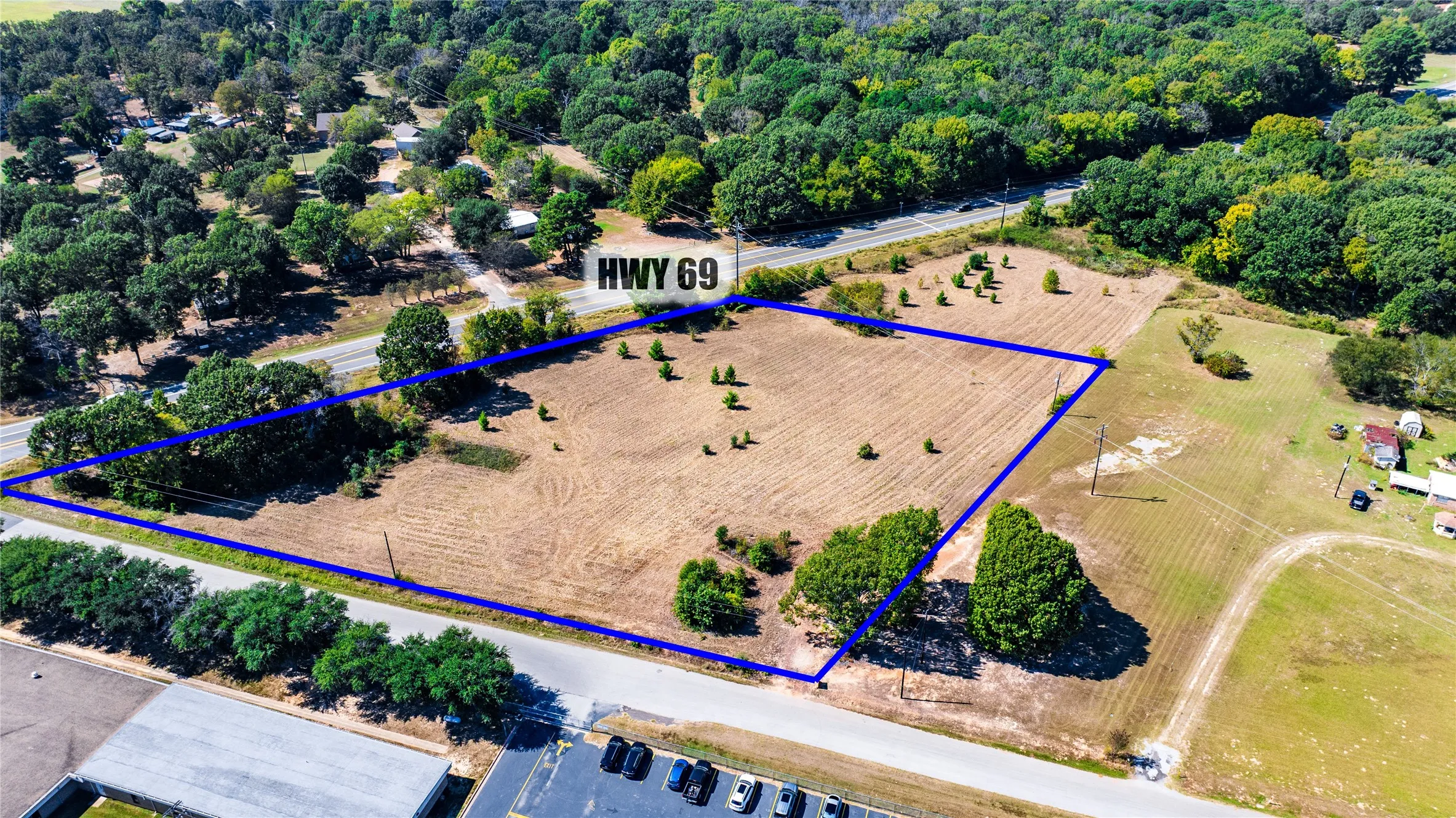 Overview of rural landscape featuring a heavily wooded area and property parcel outlined