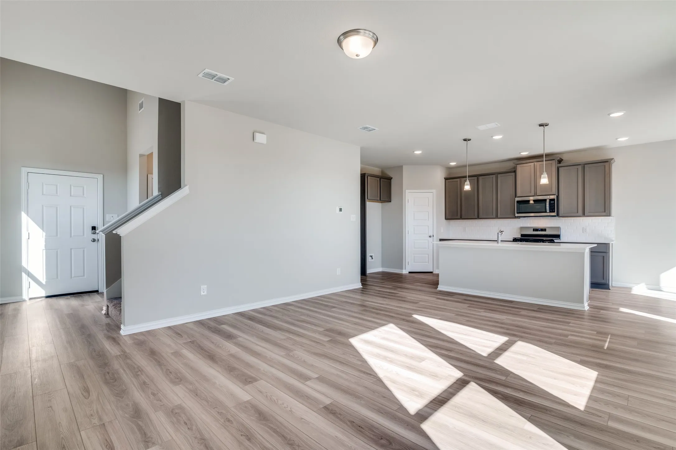 Unfurnished living room featuring light wood-type flooring and recessed lighting