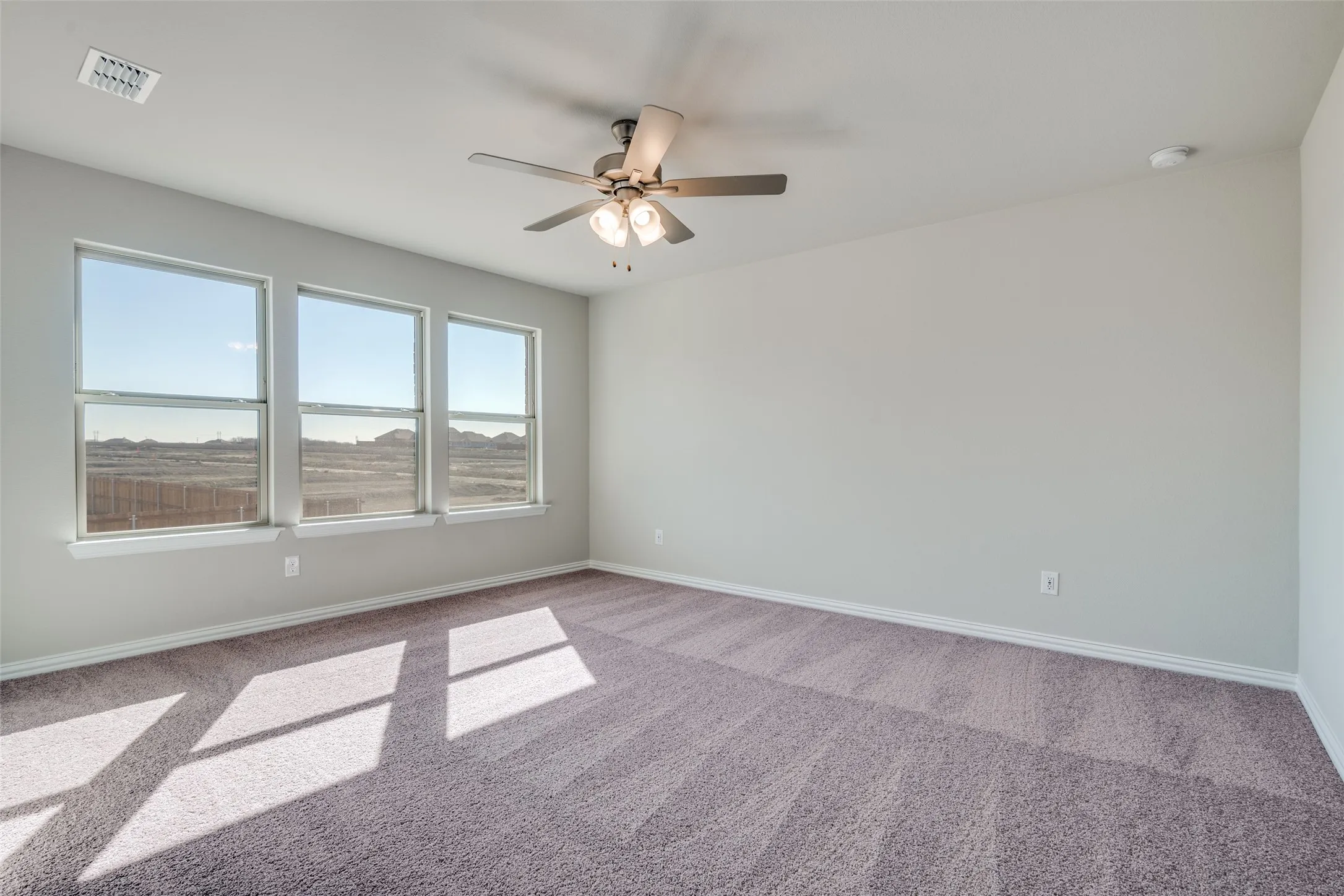 Unfurnished room with carpet floors and ceiling fan