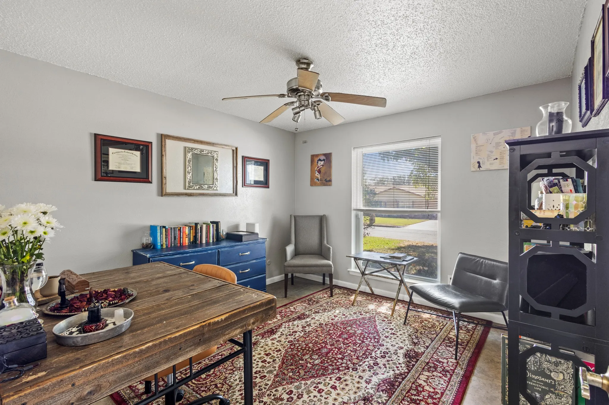 Home office featuring a textured ceiling and ceiling fan