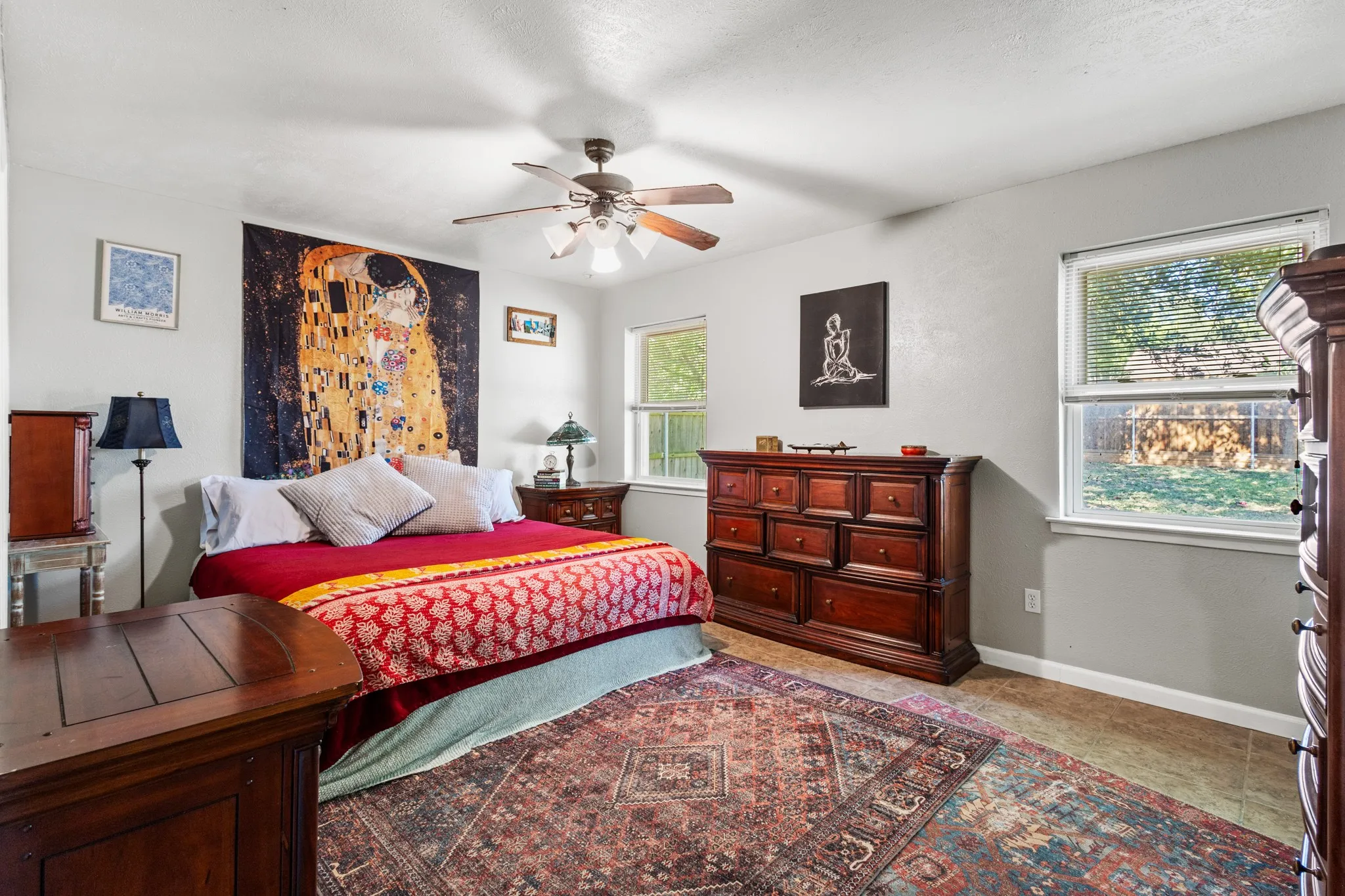 Bedroom featuring a ceiling fan and light tile patterned floors