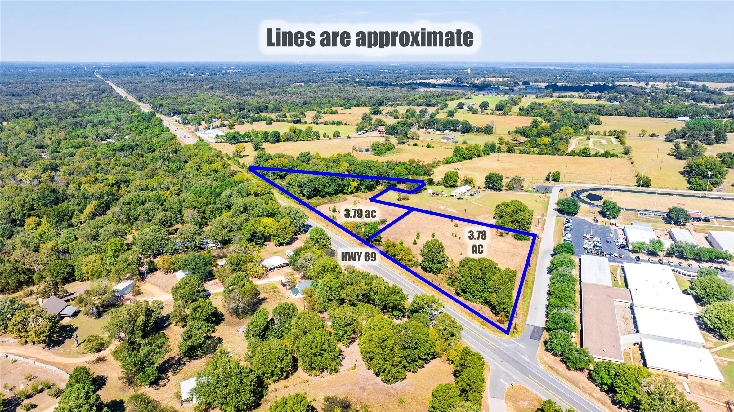 Aerial view of property and surrounding area featuring property parcel outlined
