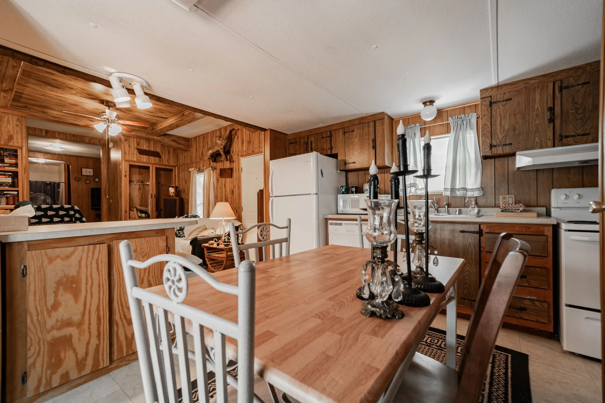 Dining room featuring light tile patterned flooring and wood walls