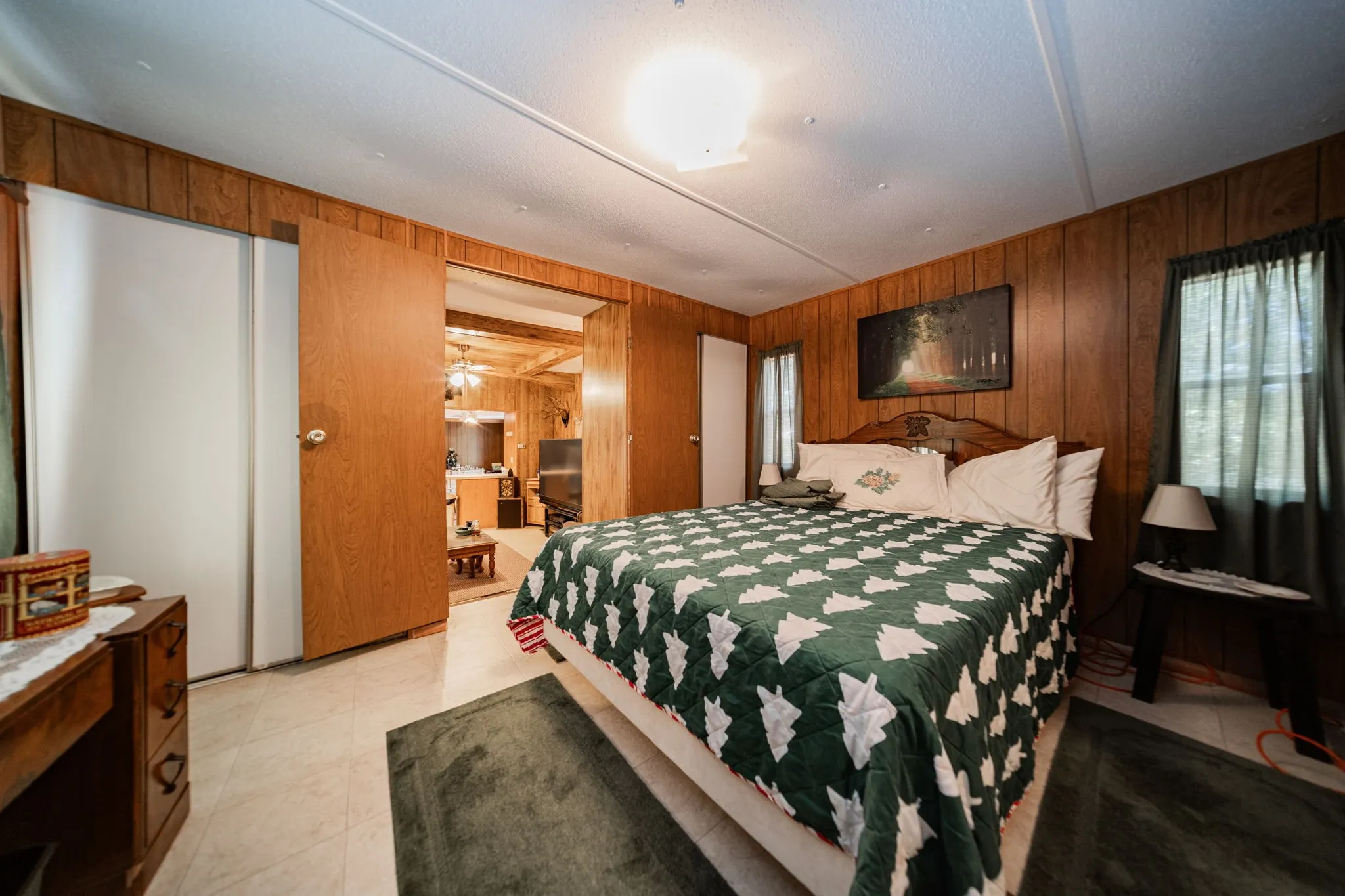 Bedroom featuring wood walls and light tile patterned flooring