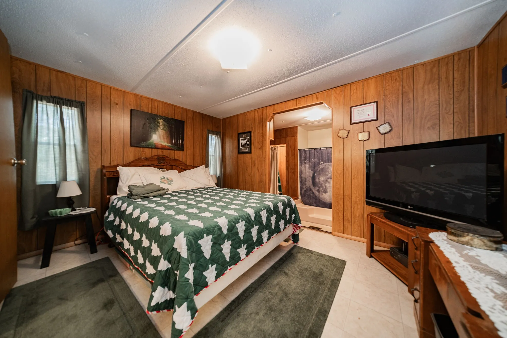 Bedroom with wood walls and light tile patterned flooring