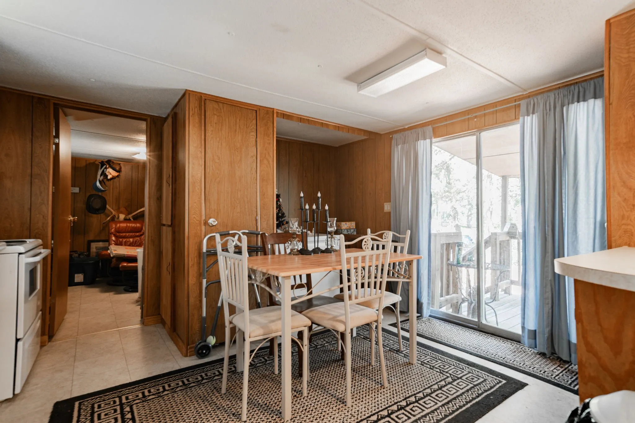 Dining area featuring wood walls and light tile patterned floors