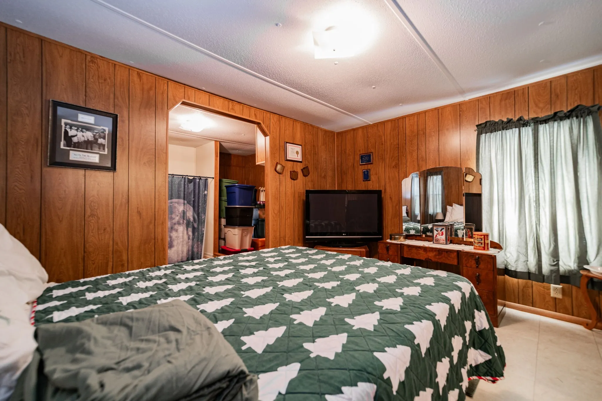 Bedroom with wood walls and light tile patterned floors