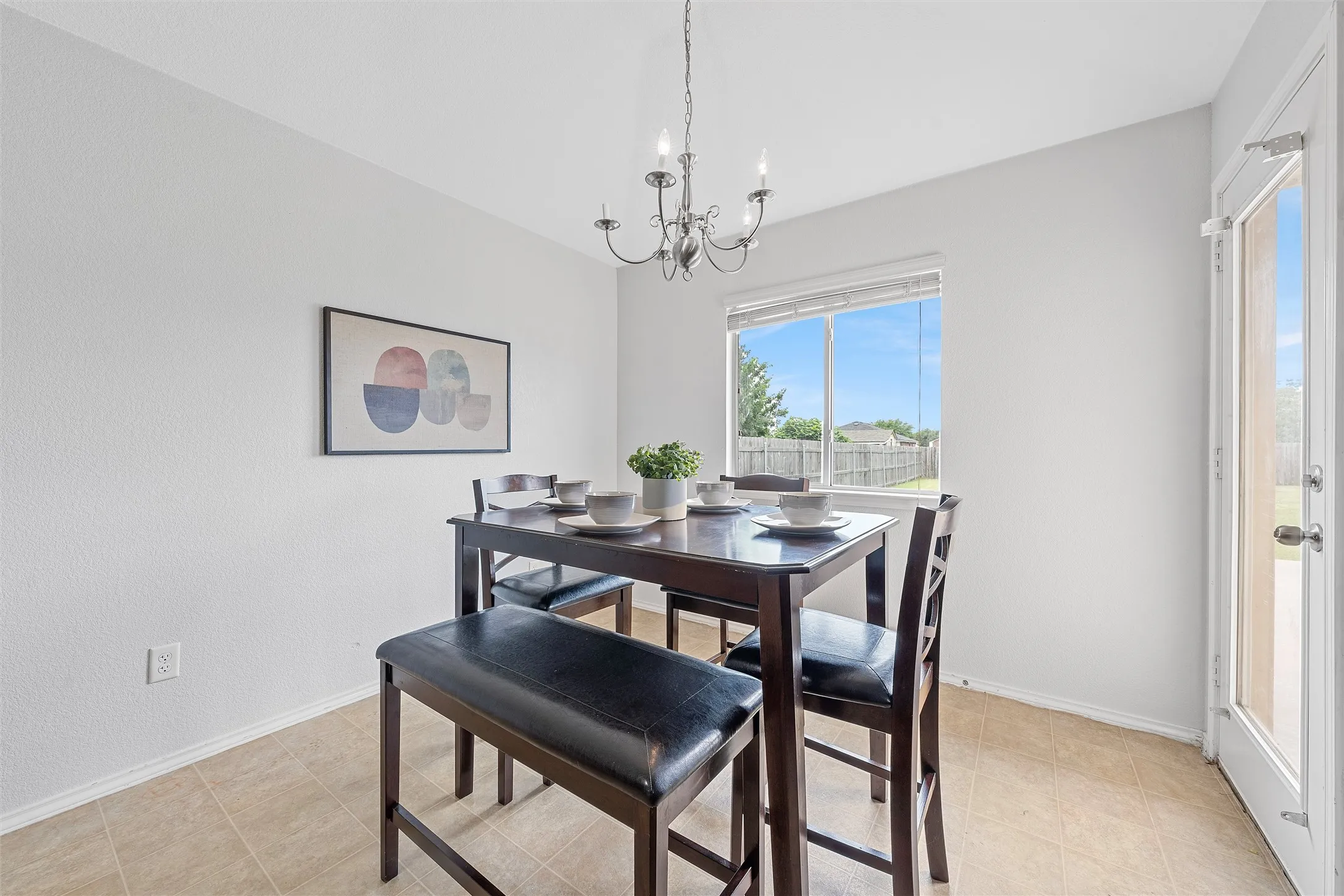 Dining area featuring a chandelier and light tile patterned flooring