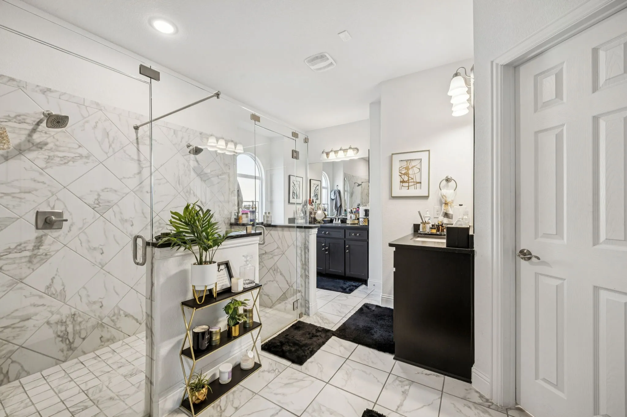 Full bathroom with vanity, a shower stall, and light marble finish flooring