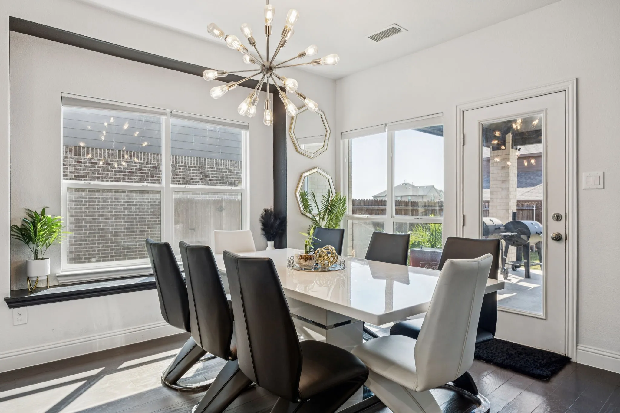 Dining space with dark wood-style flooring and a chandelier