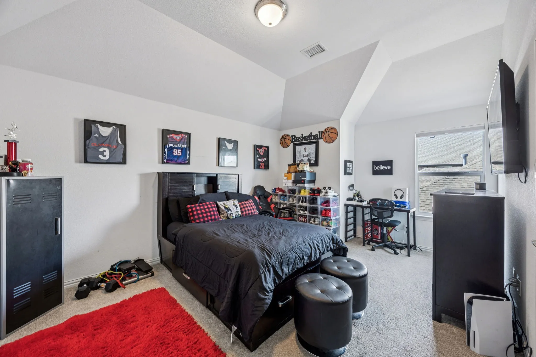 Bedroom featuring carpet flooring and lofted ceiling