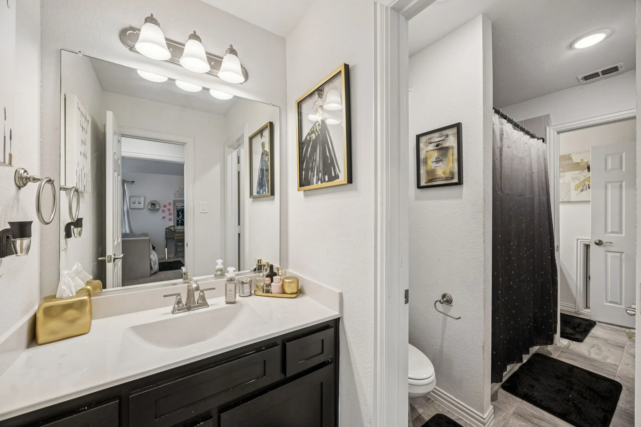 Bathroom with vanity, a textured wall, and a shower with curtain