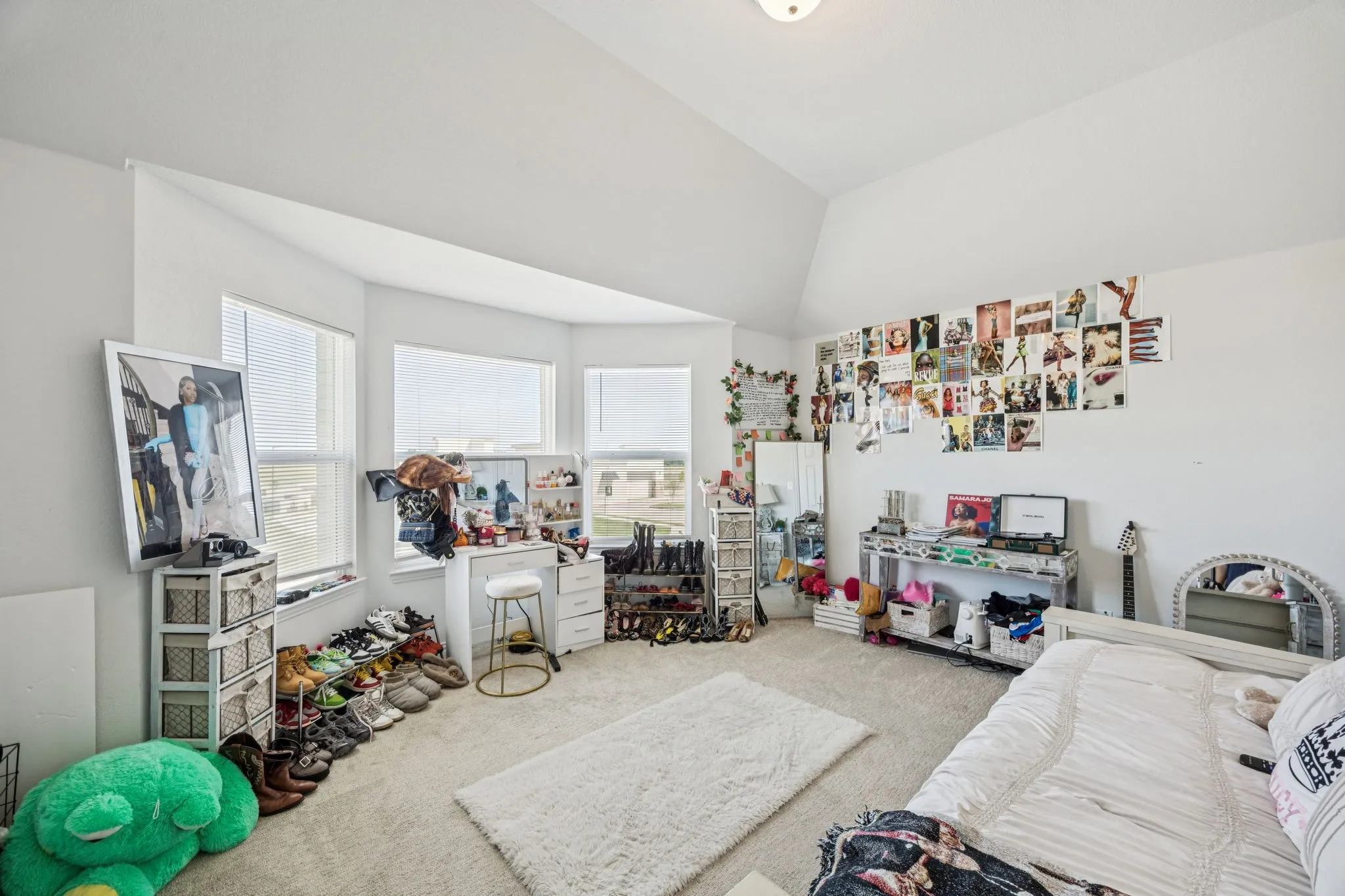 Recreation room featuring carpet flooring and vaulted ceiling