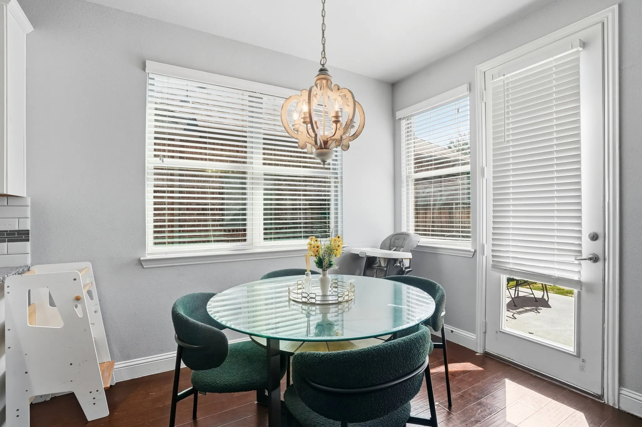 Dining space featuring plenty of natural light, dark wood-style floors, and a chandelier