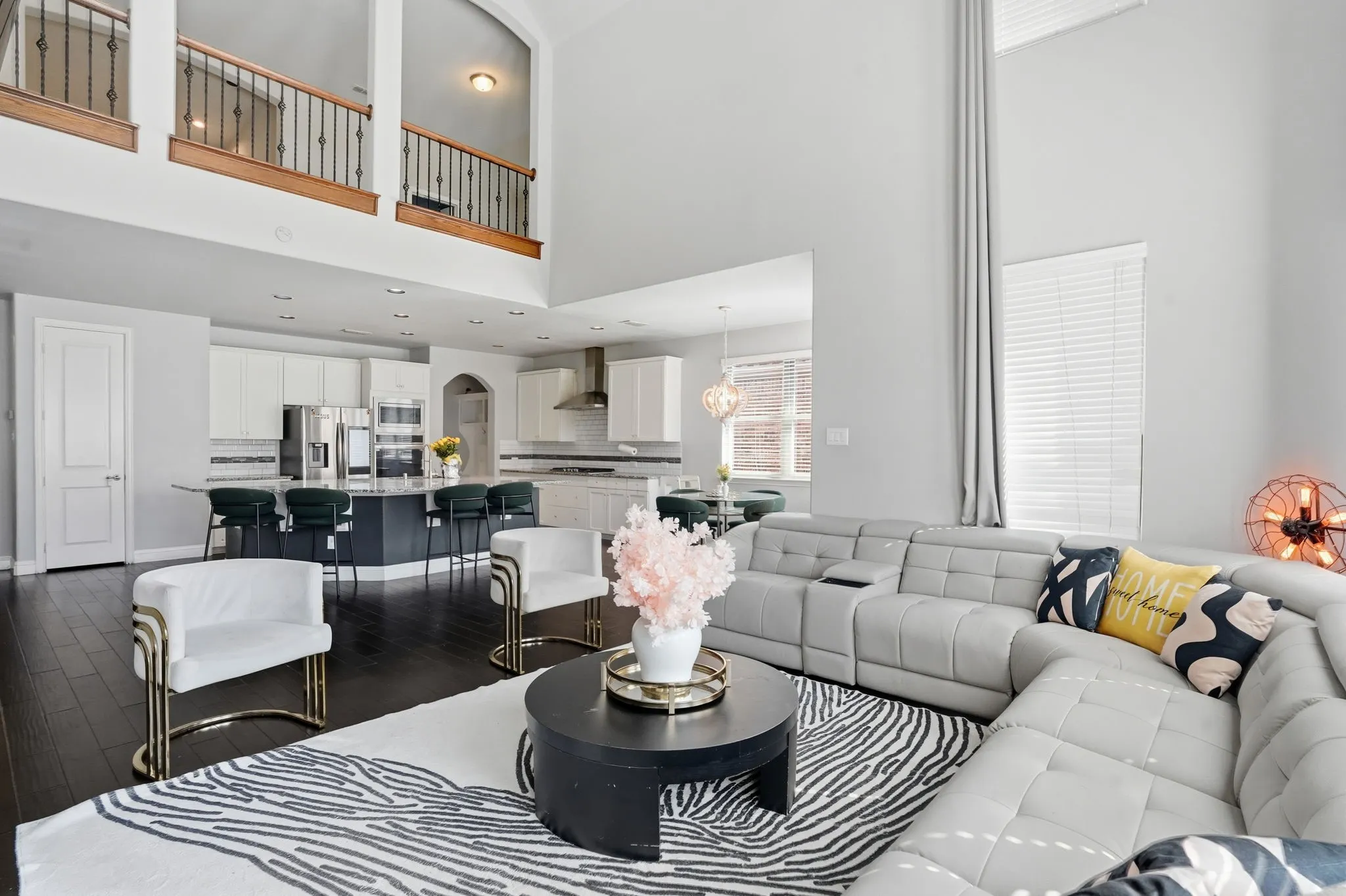 Living room with dark wood-type flooring and a towering ceiling