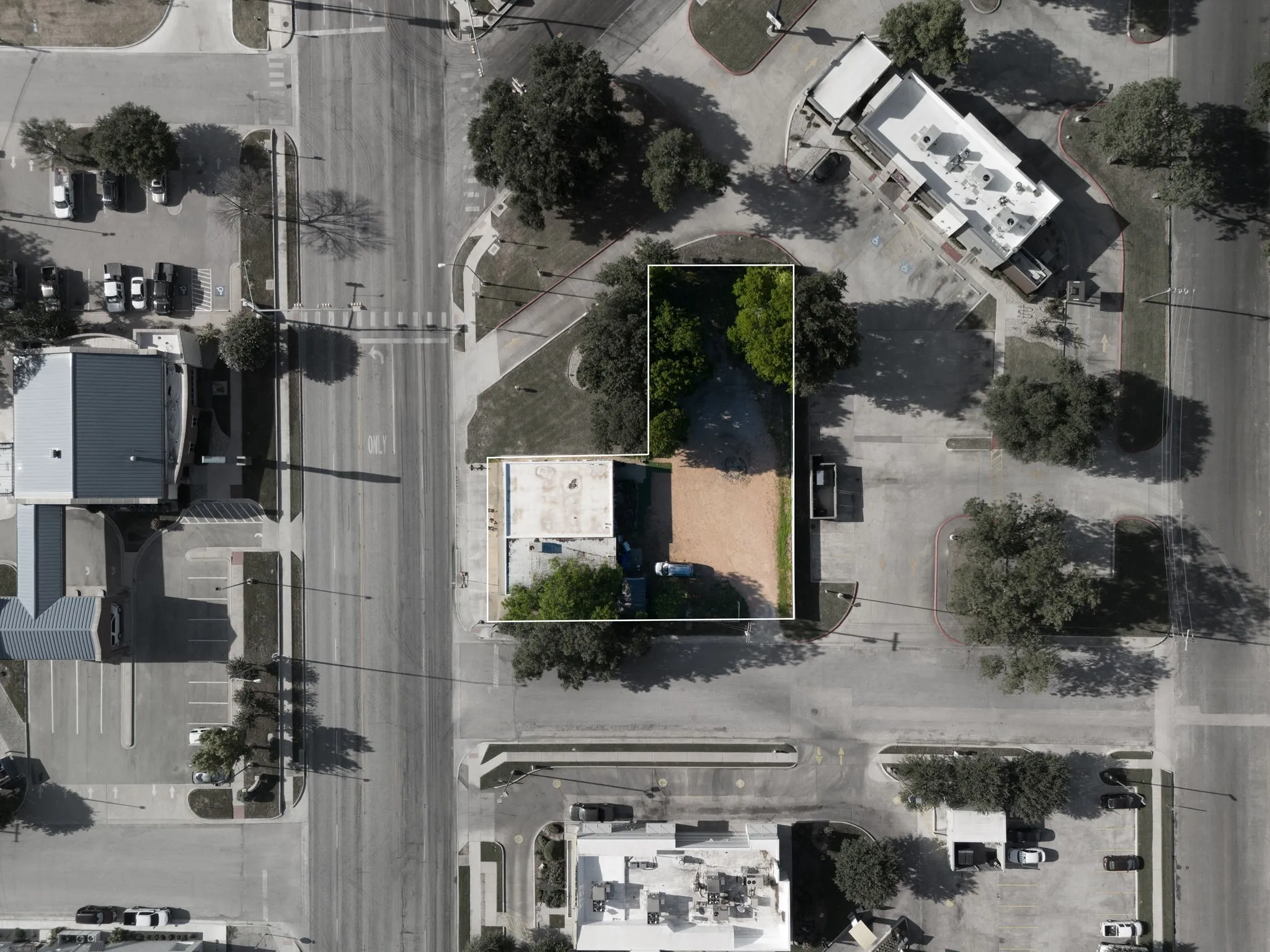 Aerial view of property and surrounding area featuring property parcel outlined