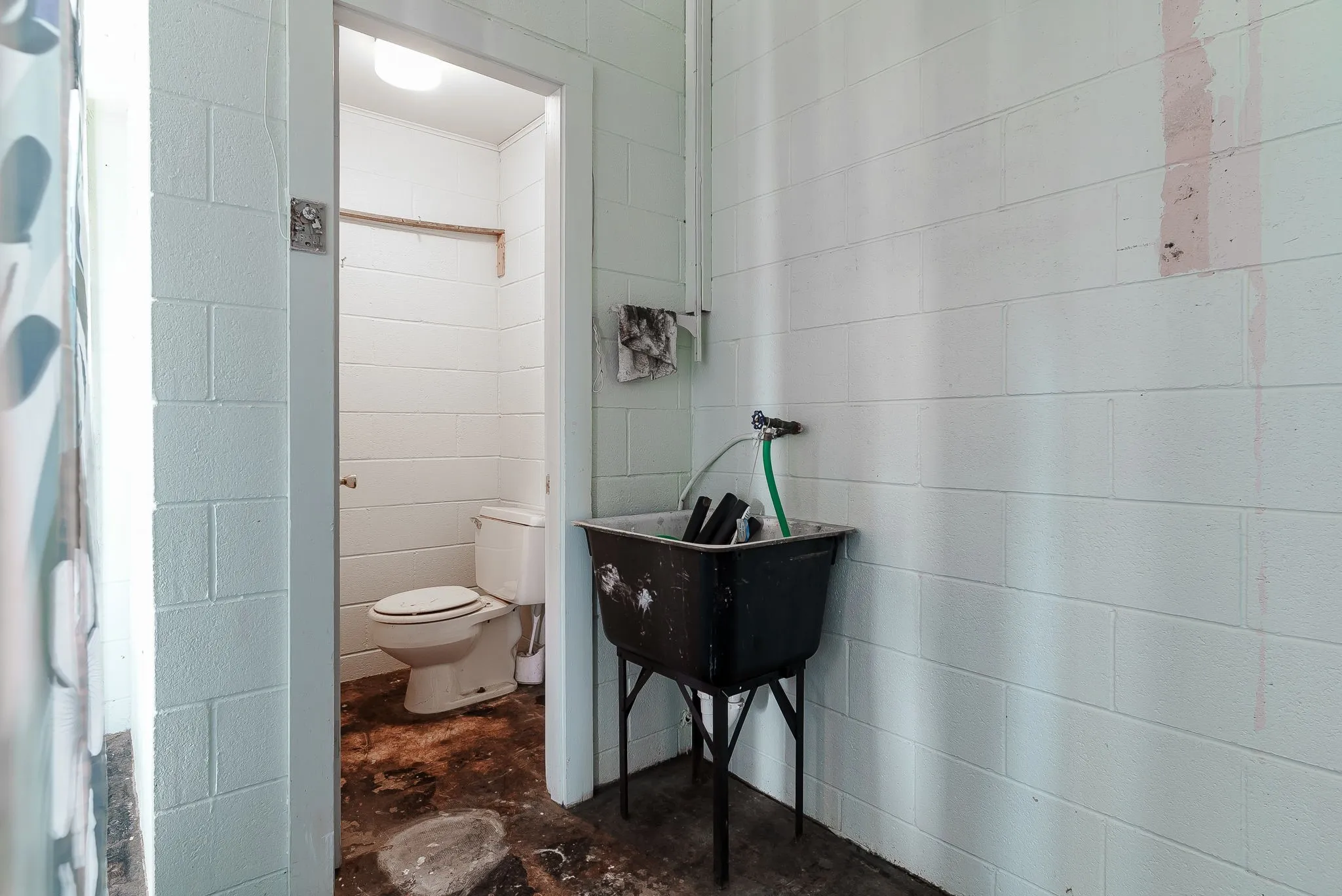 Bathroom featuring toilet and concrete floors