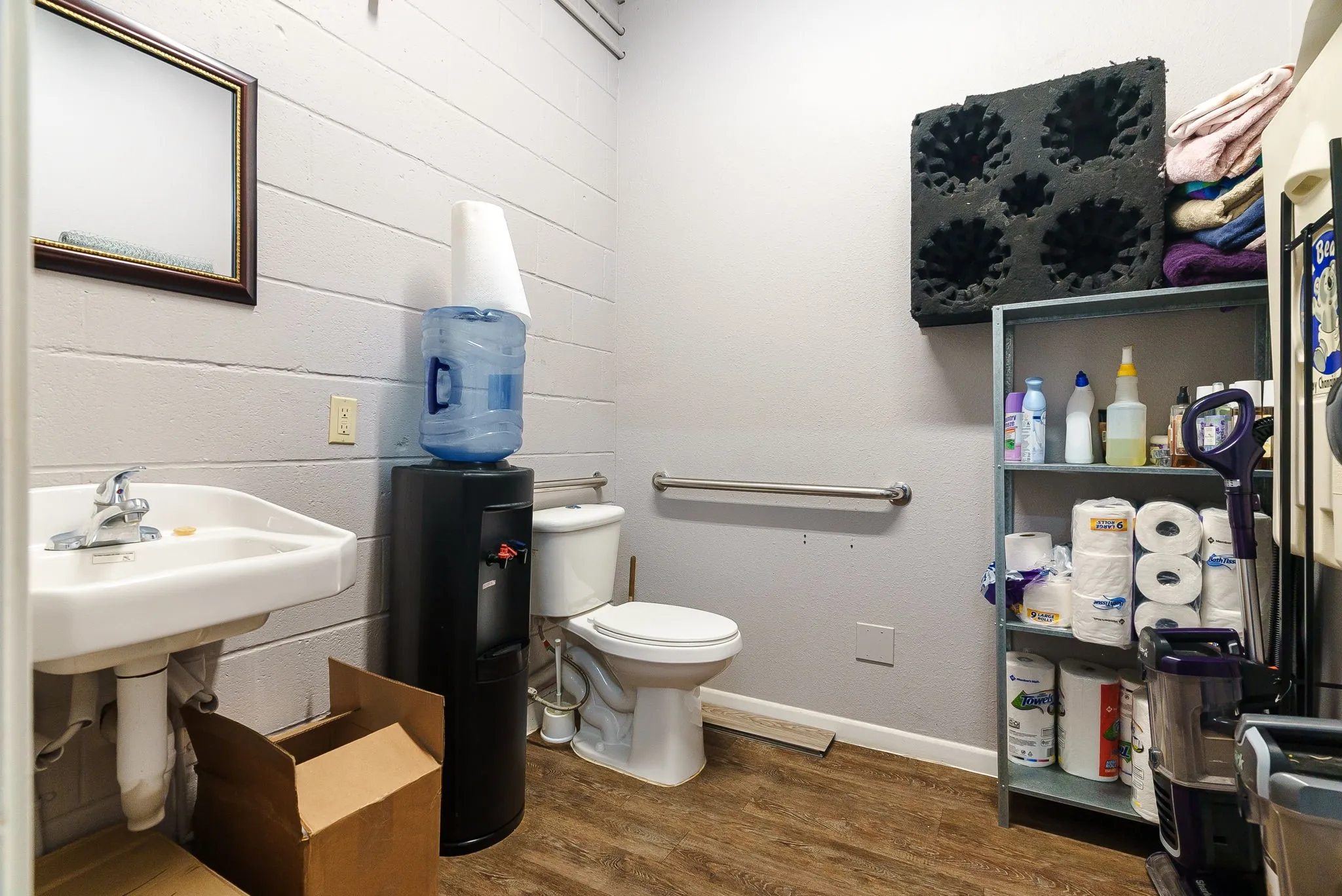 Half bathroom featuring dark wood-style floors and baseboards