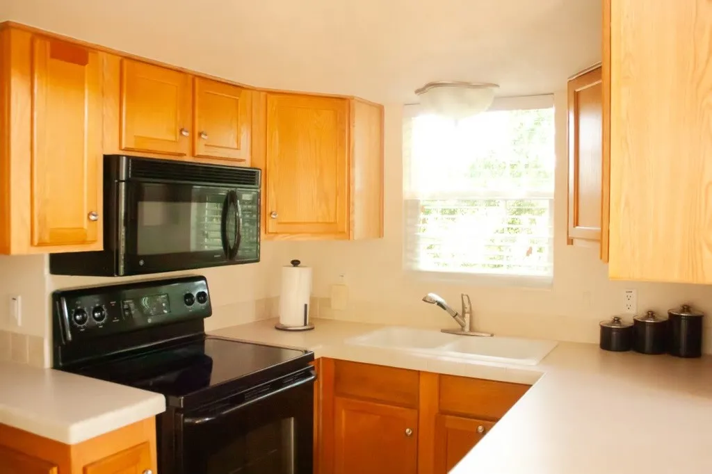 Kitchen featuring black appliances and light countertops