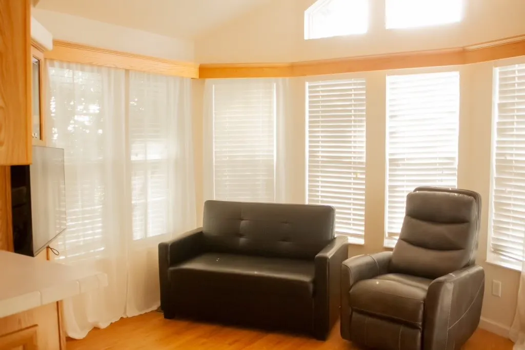 Living area with light wood finished floors and lofted ceiling