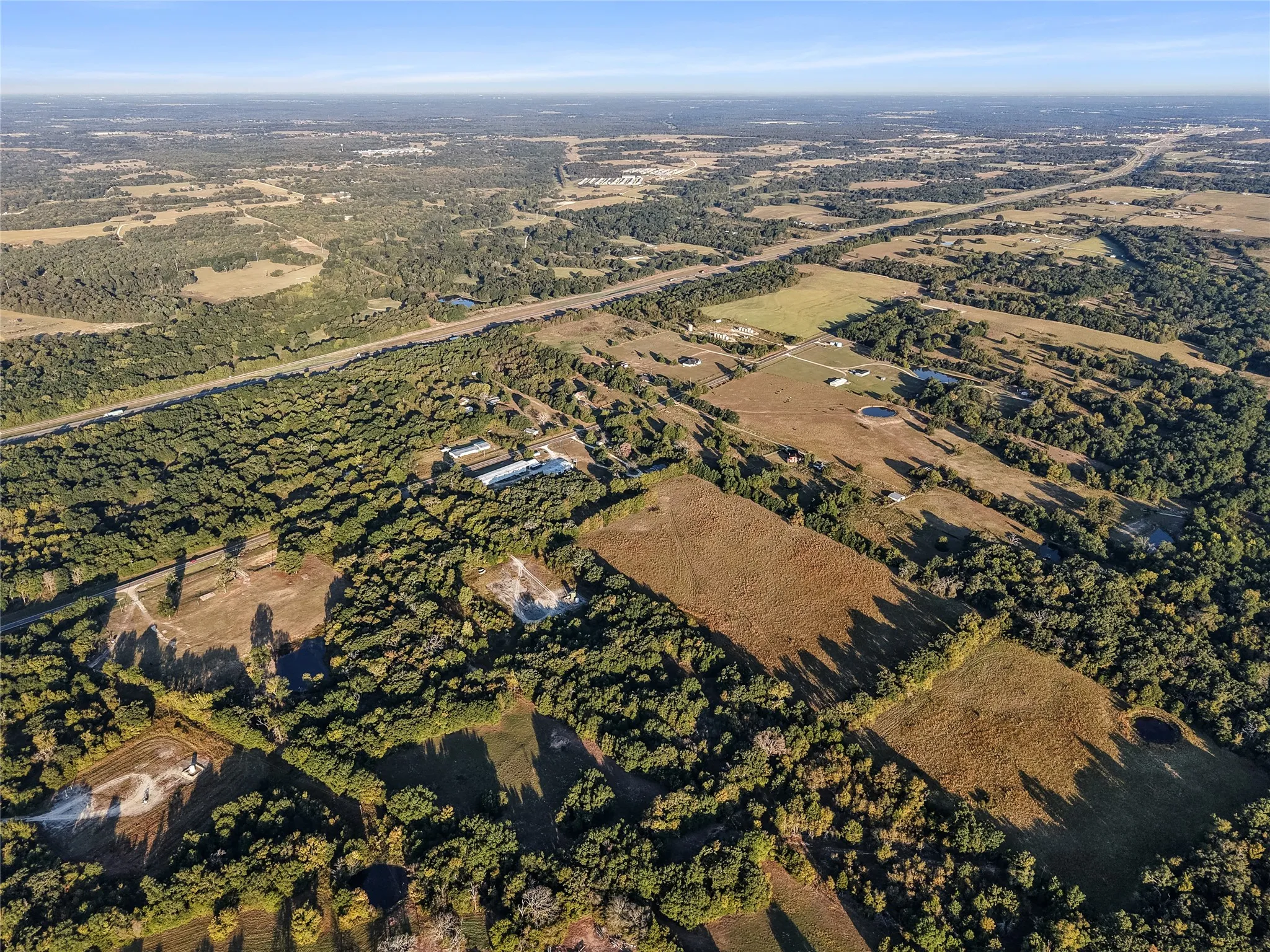 Aerial view of property and surrounding area featuring rural landscape